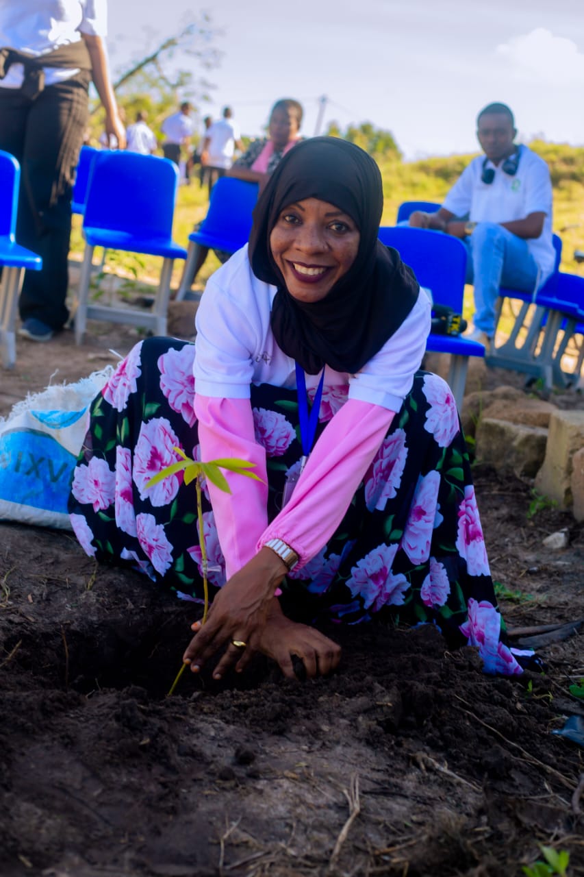 Community member planting a seedling